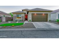 Single-story home with a two-car garage and desert landscaping at 16829 W Almeria Rd, Goodyear, AZ 85395