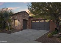 Brick home with a two car garage and desert landscaping at 28368 N 129Th Dr, Peoria, AZ 85383