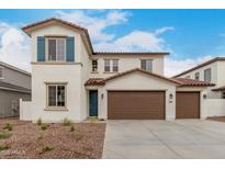 Charming two-story home featuring a terracotta roof, stucco siding, blue shutters, and a spacious three-car garage at 4924 W Beryl Ave, Glendale, AZ 85302