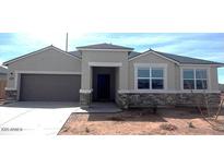 Charming single-story home featuring a neutral color scheme, stone accents, and a well-maintained lawn at 1551 E Mason Dr, Casa Grande, AZ 85122