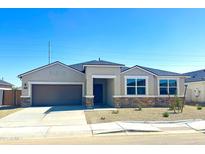 Charming single-story home featuring a two-car garage and stylish stone accents at 1551 E Mason Dr, Casa Grande, AZ 85122