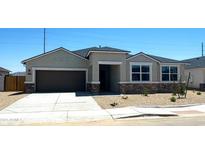 Charming single-Gathering home features a two-car garage, desert landscaping, and a covered entryway at 1551 E Mason Dr, Casa Grande, AZ 85122