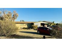 Ranch style home with carport and spacious yard at 1911 N 202Nd Ave, Buckeye, AZ 85396