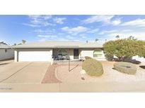 Ranch-style home with landscaped yard, driveway, and two-car garage at 7960 E Madero Ave, Mesa, AZ 85209