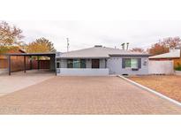 Charming single-story home with a brick driveway, carport and desert landscaping at 813 E Glendale Ave, Phoenix, AZ 85020