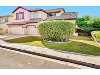 Two-story house with a landscaped front yard and attached two-car garage at 2415 W Weatherby Way, Chandler, AZ 85286