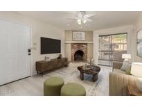 Bright living room featuring a fireplace and sliding glass door to balcony at 3031 N Civic Center Plz # 224, Scottsdale, AZ 85251