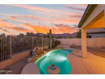 Inviting kidney-shaped pool with waterfall feature and mountain views at 7114 E Hacienda La Colorada Dr, Gold Canyon, AZ 85118