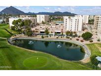 Aerial view of community featuring pool, tennis courts, and mountain views at 7940 E Camelback Rd # 404, Scottsdale, AZ 85251