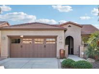 Single-story home with brown garage doors and landscaped front yard at 12951 W Andrew Ln, Peoria, AZ 85383