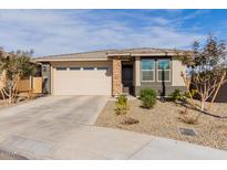 Single-story home with a two-car garage and desert landscaping at 19122 W Solano Dr, Litchfield Park, AZ 85340