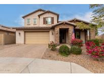 Charming two-story home featuring a brick-accented entrance, tan stucco, and an attached two-car garage at 19544 W Lincoln St, Buckeye, AZ 85326