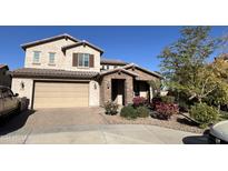 Two-story house with brick and stucco exterior, landscaping, and a two-car garage at 19544 W Lincoln St, Buckeye, AZ 85326