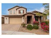 Two-story house with tan exterior, brown accents, and landscaping at 19544 W Lincoln St, Buckeye, AZ 85326