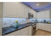 Modern kitchen with stainless steel appliances and granite countertops at 72 E Camellia Way, Queen Creek, AZ 85140