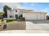 Two-story house with a three-car garage and landscaped front yard at 1021 E Mead Dr, Chandler, AZ 85249