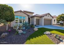 Single-story home with desert landscaping, two-car garage, and attractive facade at 16807 W Berkeley Rd, Goodyear, AZ 85395