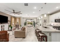 Open concept kitchen with island, stainless steel appliances, and white cabinetry at 20385 W Vista Paseo Dr, Buckeye, AZ 85396