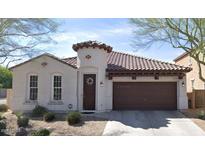 Charming single-story home with a tile roof, brown garage door and inviting front entrance with a decorative wreath at 2133 E La Salle St, Phoenix, AZ 85040