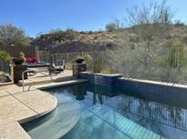 Inviting backyard oasis featuring a sparkling pool, spa, and ample patio space at 4742 S Primrose Dr, Gold Canyon, AZ 85118