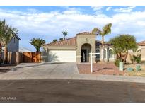 One-story house with a two-car garage, and desert landscaping at 702 E Nancy Ave, San Tan Valley, AZ 85140