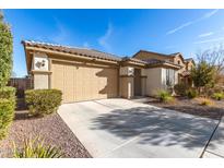 House exterior featuring a two-car garage and well-manicured landscaping at 27227 N 171St Dr, Surprise, AZ 85387