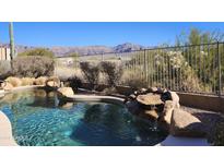 Beautiful pool with a waterfall feature and mountain views at 4361 S Tigre Del Mar Dr, Gold Canyon, AZ 85118