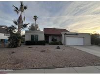 One-story house with red tile roof, attached garage, and desert landscaping at 4709 W Westcott Dr, Glendale, AZ 85308