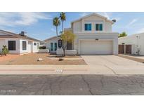 Two-story house with white exterior, two-car garage, and landscaped front yard at 609 W Grandview Rd, Phoenix, AZ 85023