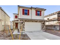 Two-story home with stone accents and red shutters at 7423 W Cavalier Dr, Glendale, AZ 85303