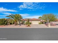 Single-story home with desert landscaping and a two-car garage at 10442 E Flintlock Dr, Sun Lakes, AZ 85248