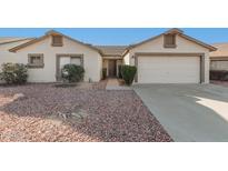 White single story home with two-car garage and landscaped front yard at 10831 W Laurie Ln, Peoria, AZ 85345