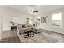 Bright living room featuring a comfy sectional sofa, stylish coffee table, and large windows at 619 E Jensen St # 55, Mesa, AZ 85203