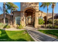 Elegant home exterior with arched entryway and landscaping at 9053 N 46Th St, Phoenix, AZ 85028
