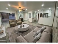 Open living room with modern decor, plush seating, and view to the backyard pool area at 102 W Maryland Ave # F1, Phoenix, AZ 85013