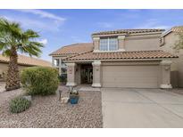 Two-story house with tan exterior, tile roof, and landscaped front yard at 5951 E Trailridge St, Mesa, AZ 85215