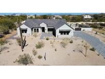 Beautiful modern home showcasing desert landscaping, a paver driveway, and a neutral color palette at 8714 E Tether Trl, Scottsdale, AZ 85255