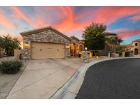 Beautiful stone house with a three-car garage and nicely landscaped front yard at 11714 N 134Th St, Scottsdale, AZ 85259