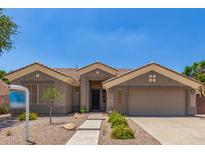 Charming single-story home featuring a low maintenance front yard and a two-car garage at 1231 W Hawken Way, Chandler, AZ 85286