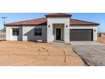 Single-story home with tile roof and two-car garage at 21165 W Carver Rd, Buckeye, AZ 85326
