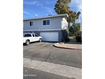 Gray duplex with attached garage and driveway, offering convenient parking at 2687 W Ocotillo Rd, Phoenix, AZ 85017