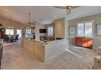 Spacious living room with vaulted ceilings, fireplace, and ample natural light at 3212 E Desert Cove Ave, Phoenix, AZ 85028