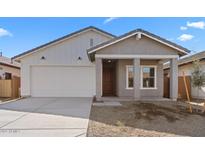 Charming single-Gathering home with a two-car garage, a covered porch, and desert landscaping at 7637 W Minton St, Laveen, AZ 85339