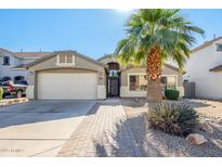 Single-story home with a two-car garage and desert landscaping at 1435 E Debbie Dr, San Tan Valley, AZ 85140