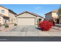 House exterior featuring a two-car garage and landscaping at 22814 W Cantilever St, Buckeye, AZ 85326