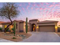 One-story home with a desert landscape and driveway at 11157 E Greenway Rd, Scottsdale, AZ 85255
