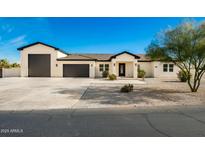 New construction home with a modern design, featuring a large driveway and two-car garage at 2917 N Katie Ln, Litchfield Park, AZ 85340