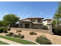 Two-story house with a gated entrance and desert landscaping at 9311 E Kiowa Ave, Mesa, AZ 85209