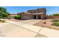 Two-story house with a three-car garage and landscaped yard at 19731 E Arrowhead Trl, Queen Creek, AZ 85142