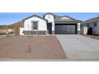 Single-story home with stone accents and a two-car garage at 7446 W Whitehorn Trl, Peoria, AZ 85383